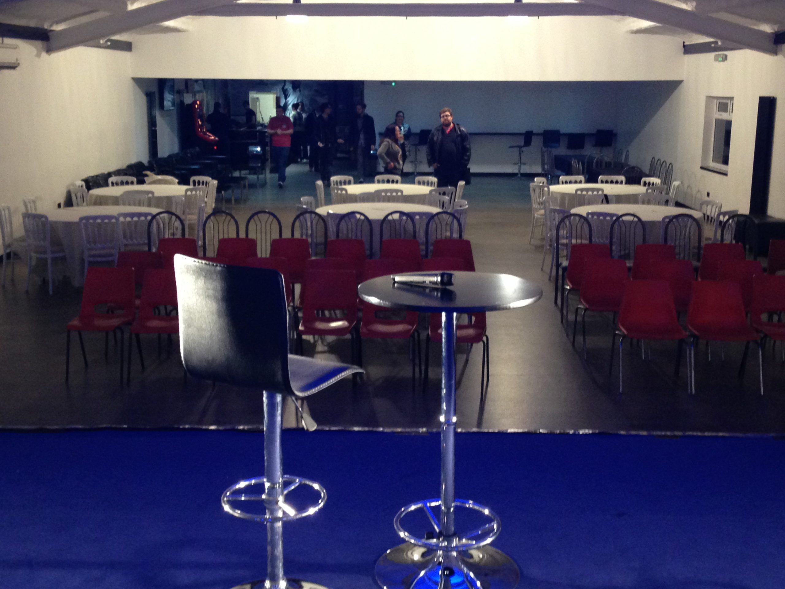 Rows of chairs facing a stage in the hall, set out for a talk or presentation.